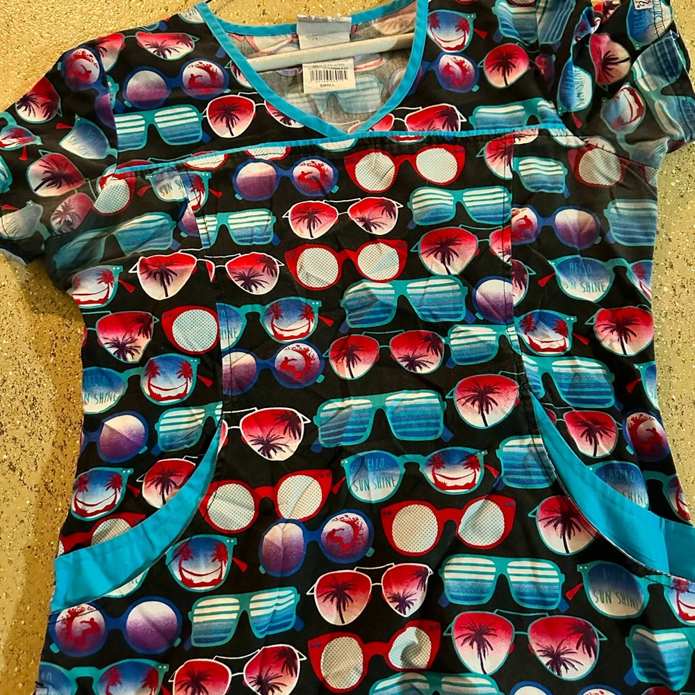 Beautiful, colorful uniform top.  Used Been boxed up. True size